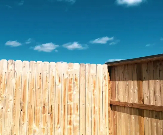 The inside corner of a natural wood cedar fence